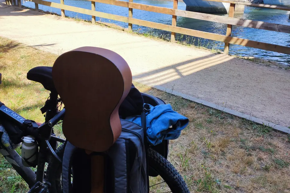 Loaded bike on a wooden boardwalk with the sea just behind