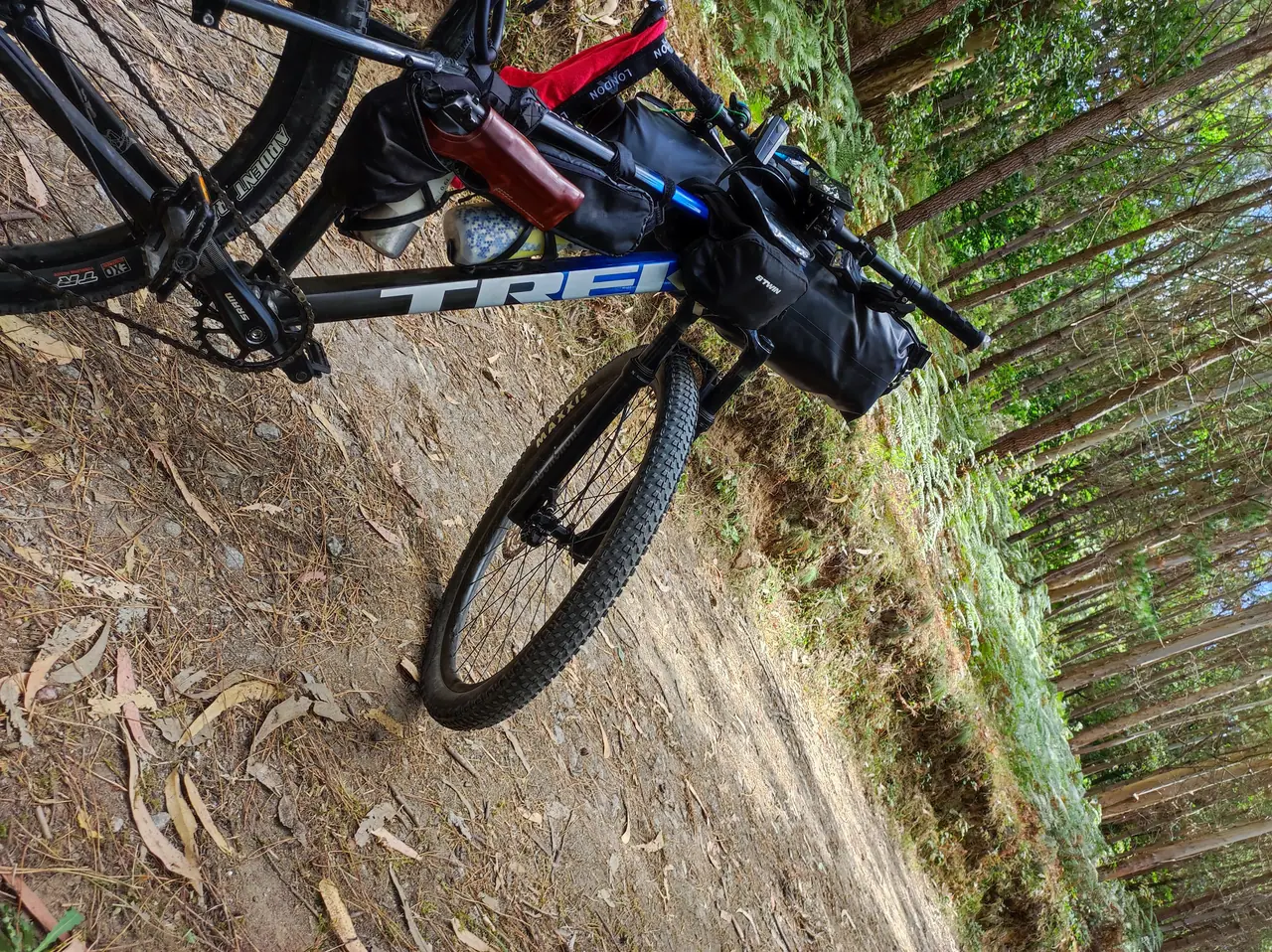 Close view of a loaded touring bicycle, frame, wheel and travel bags