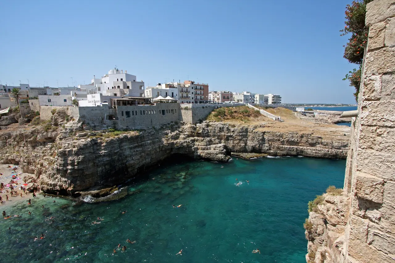 The white houses of Polignano a Mare's old town perched on the cliff above the Adriatic sea